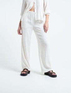 Flowy fabric pants.  • Ruffled waistband.  • Patch pockets on the front.