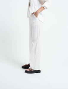 Flowy fabric pants.  • Ruffled waistband.  • Patch pockets on the front.